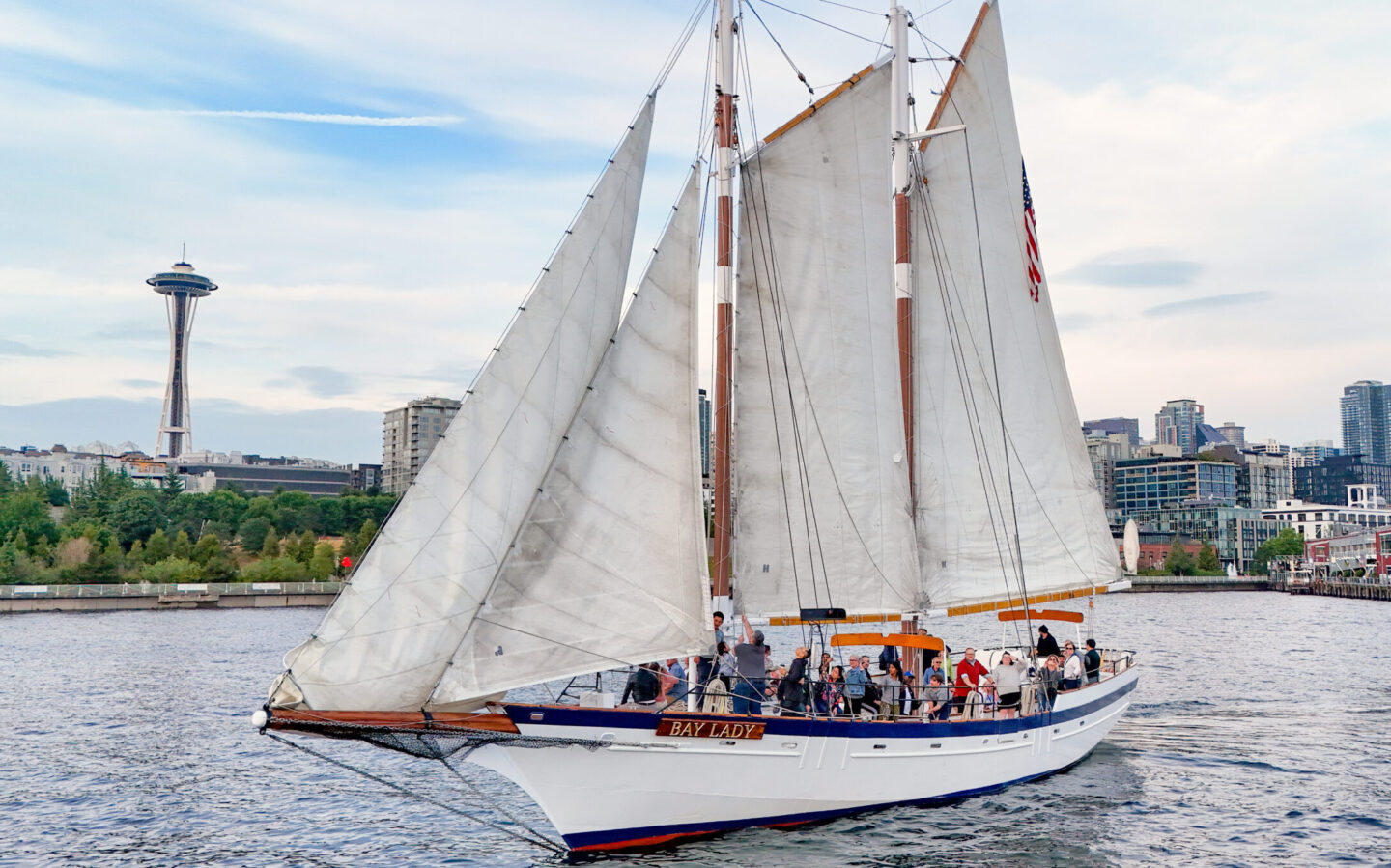 Seattle's Tall Ship sailboat in front of the Space Needle and Seattle skyline.