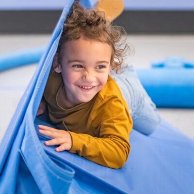 Seattle Children's Museum  child plays and smiles.