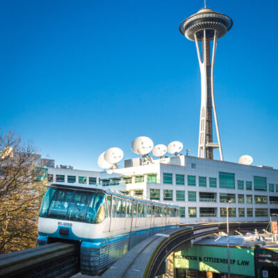 Seattle Monorail Blue Train with Space Needle behind.