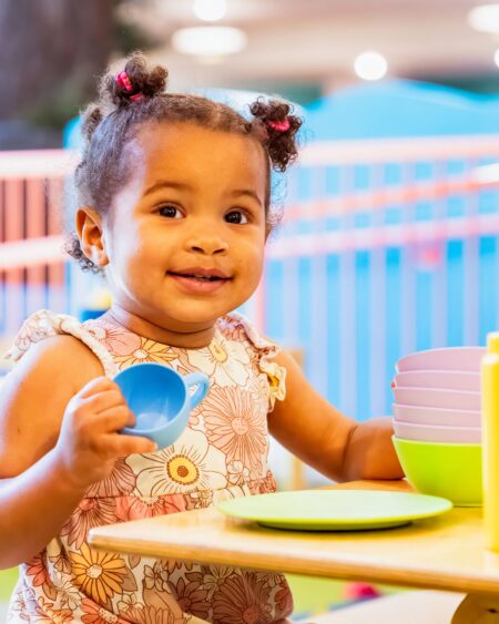 Child smiling and playing at Seattle Children's Musuem.