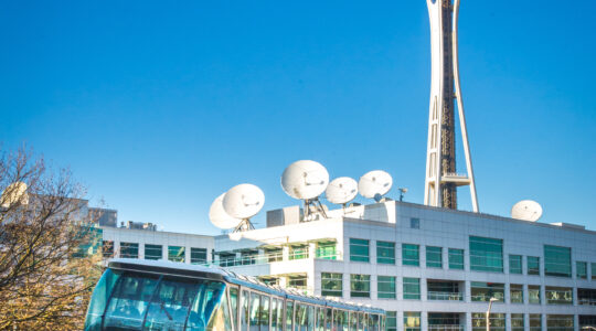 Seattle Monorail Blue Train with Space Needle behind.