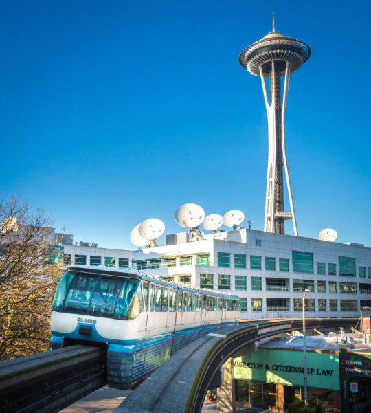 Seattle Monorail Blue Train with Space Needle behind.