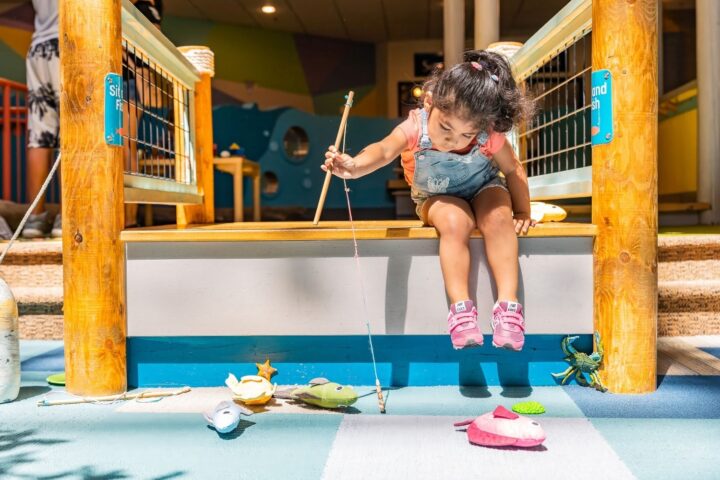 Seattle Children's Museum Girl plays at fish activation.