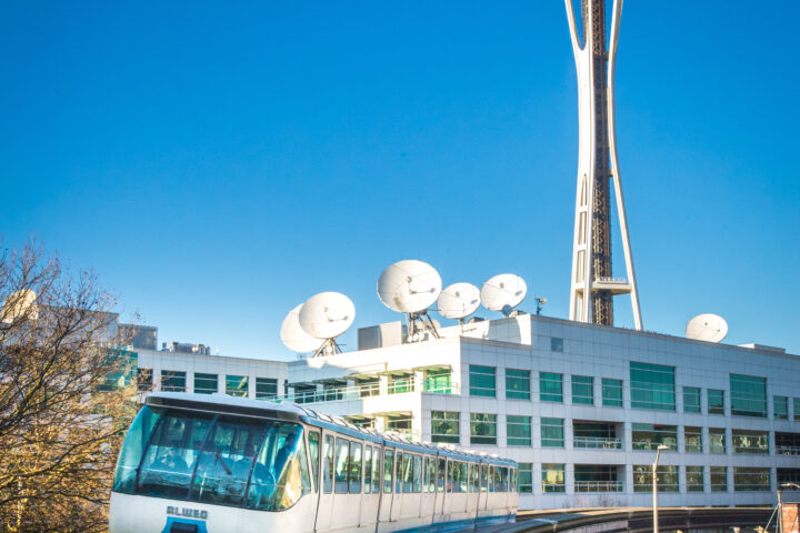 Seattle Monorail Blue Train with Space Needle behind.