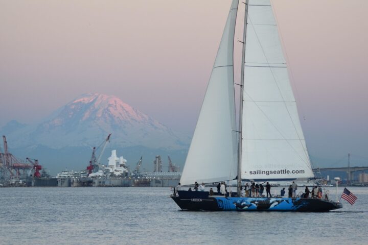 Sailing Seattle Downtown Sail boat at sunset with mount rainier in the background.