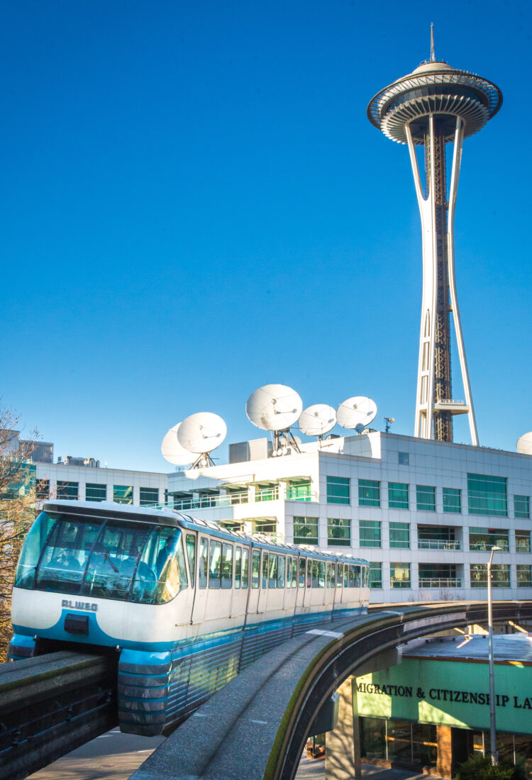 Seattle Monorail Blue Train with Space Needle behind.